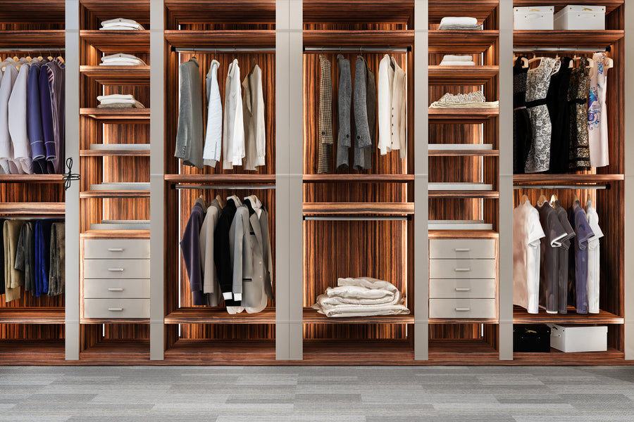 Wooden wardrobe with clothes on hangers and folded garments